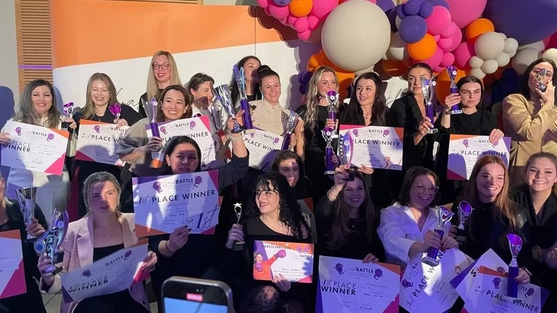 How lash competitions can transform your career Confident-lash-artist-holding-a-trophy-or-award-plaque-after-winning-a-lash-competition