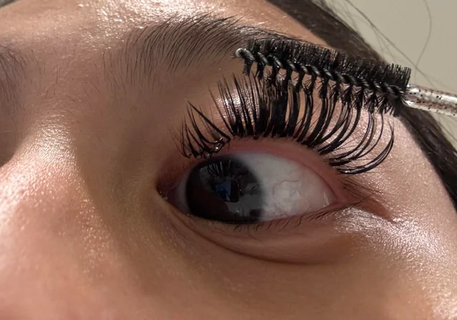 Close-up-of-brushing-wet-lash-extensions